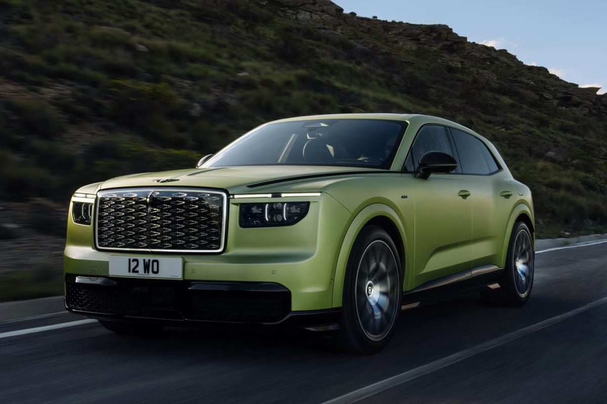 Green Bentley Torcal electric SUV driving on a mountain road