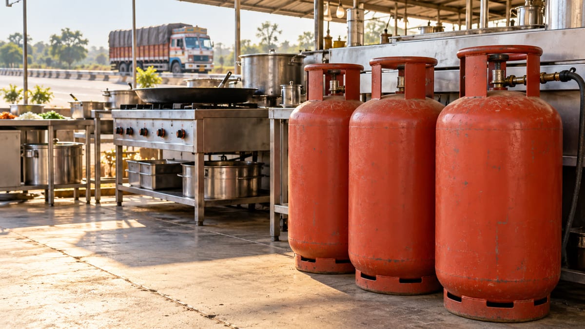 Illustrative blank commercial LPG cylinders beside a highway-side Indian kitchen