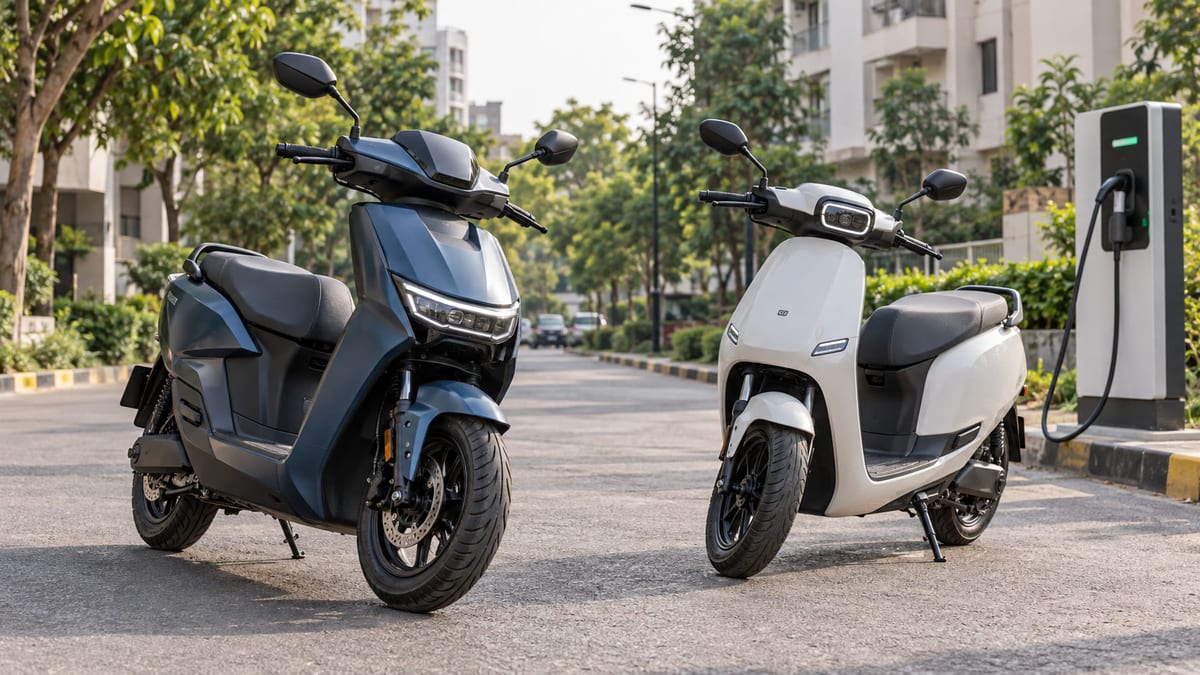 Two unbranded electric scooters parked beside an urban charging point in India
